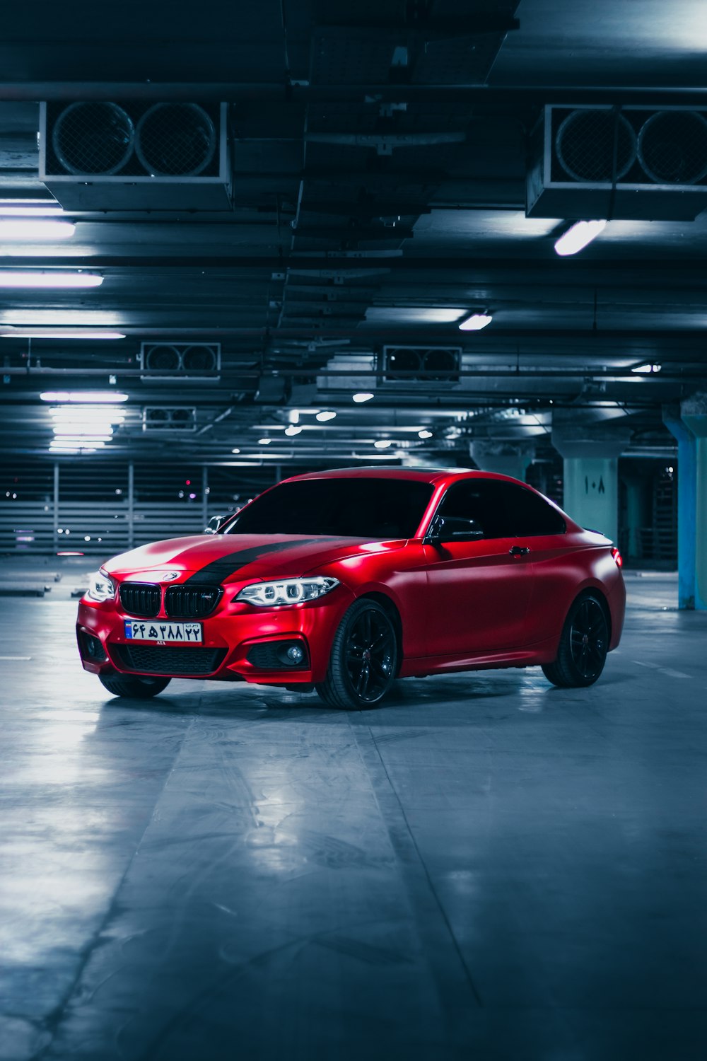 a red car parked in a parking garage