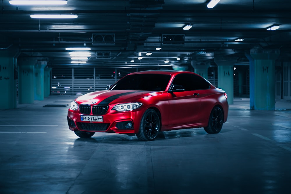 a red car parked in a parking garage