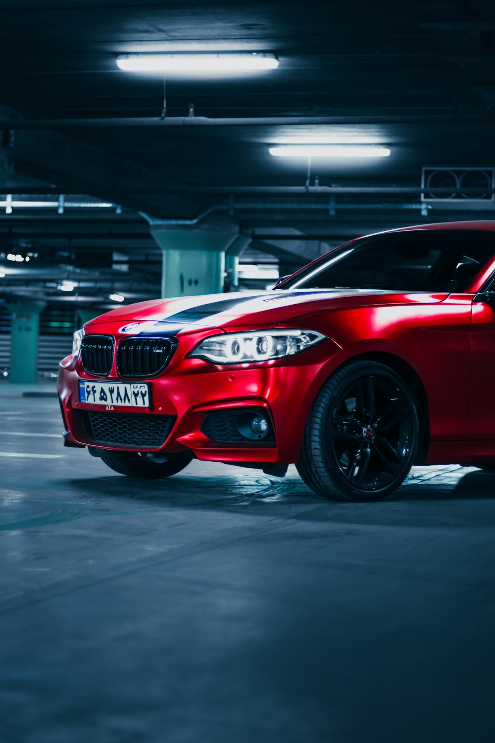 a red car parked in a parking garage