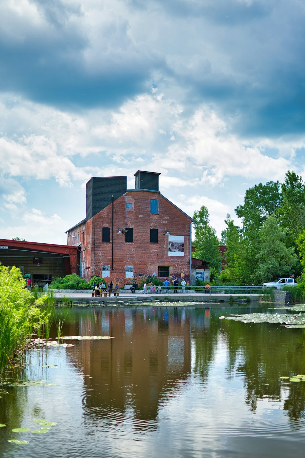 a large brick building next to a body of water