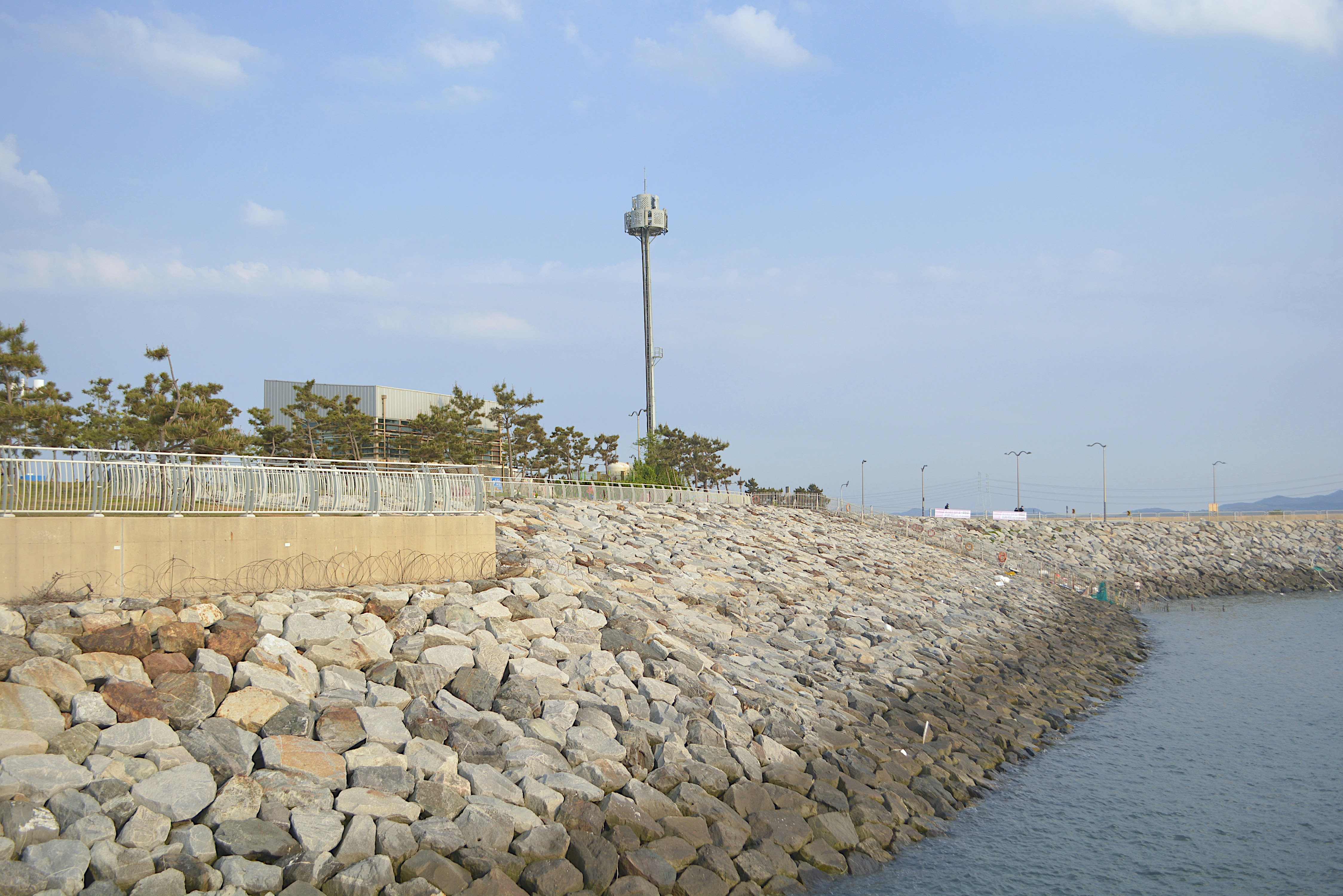 Shoreline project using custom retaining walls, strategic drainage, and anchored marine structures - coastal erosion control