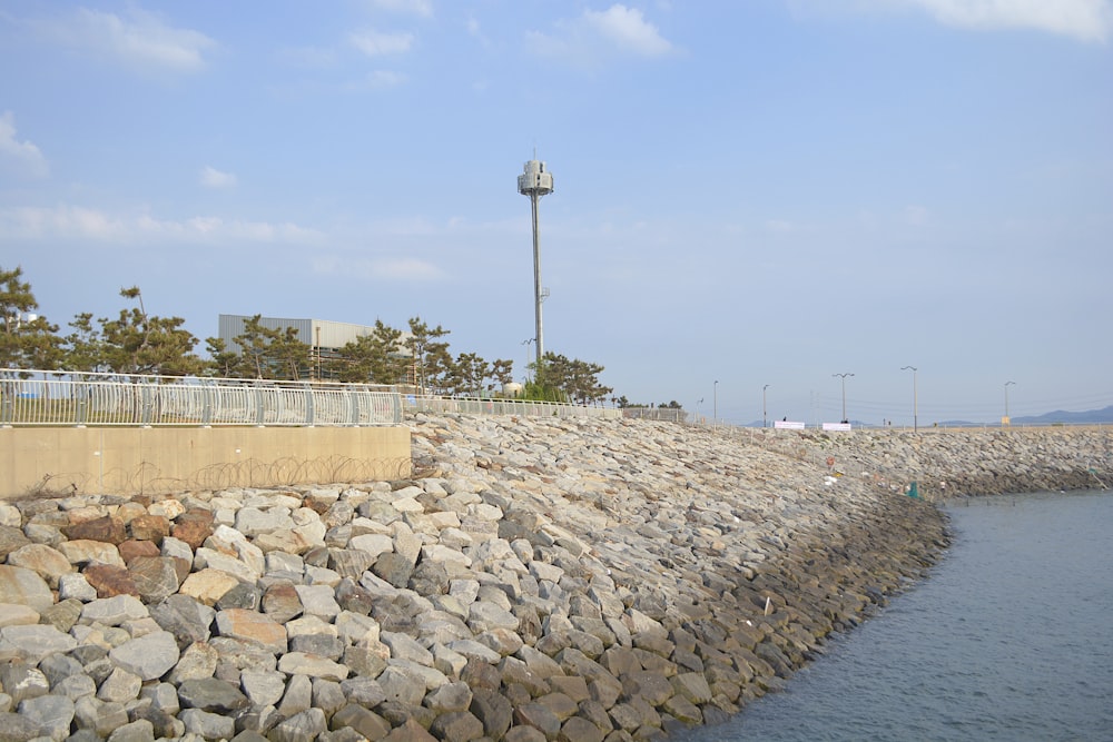 a stone wall next to a body of water