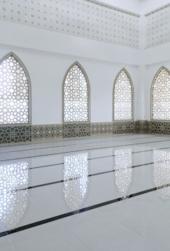 Glass storefront with Islamic design elements in a commercial area.