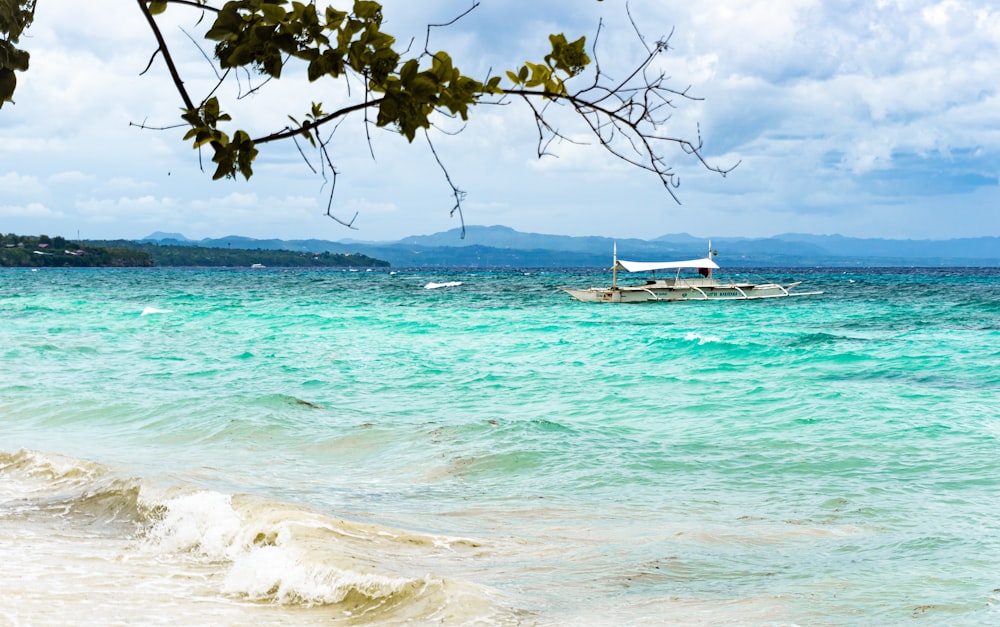 a boat floating on top of a large body of water