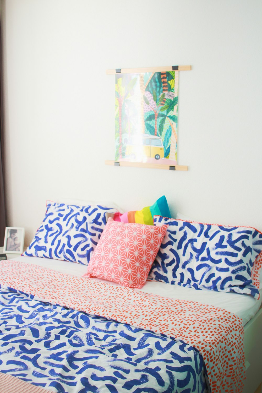 a bed with a colorful comforter and pillows