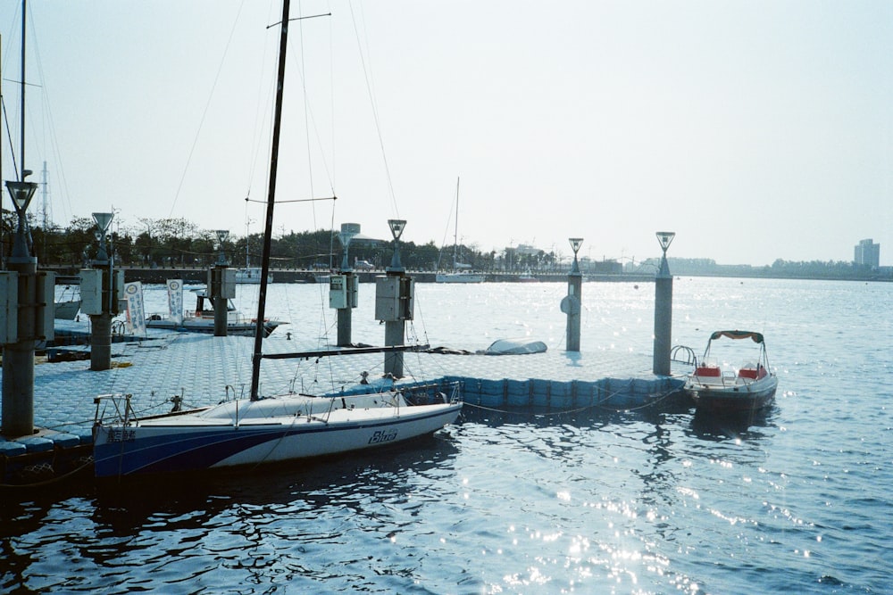 a small boat is docked at a pier
