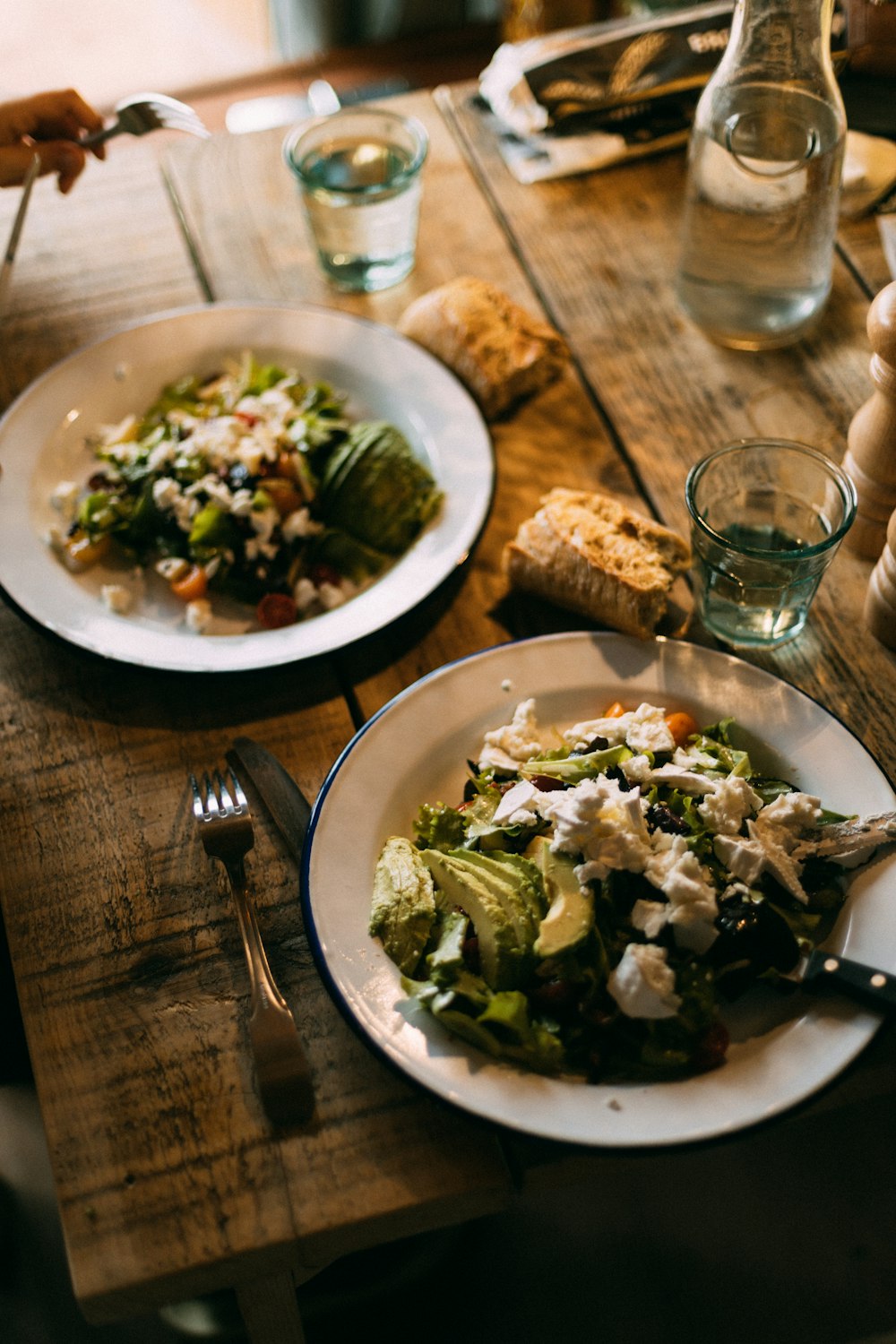 a wooden table topped with plates of food