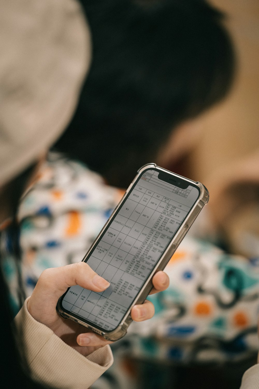 a person holding a cell phone in their hand