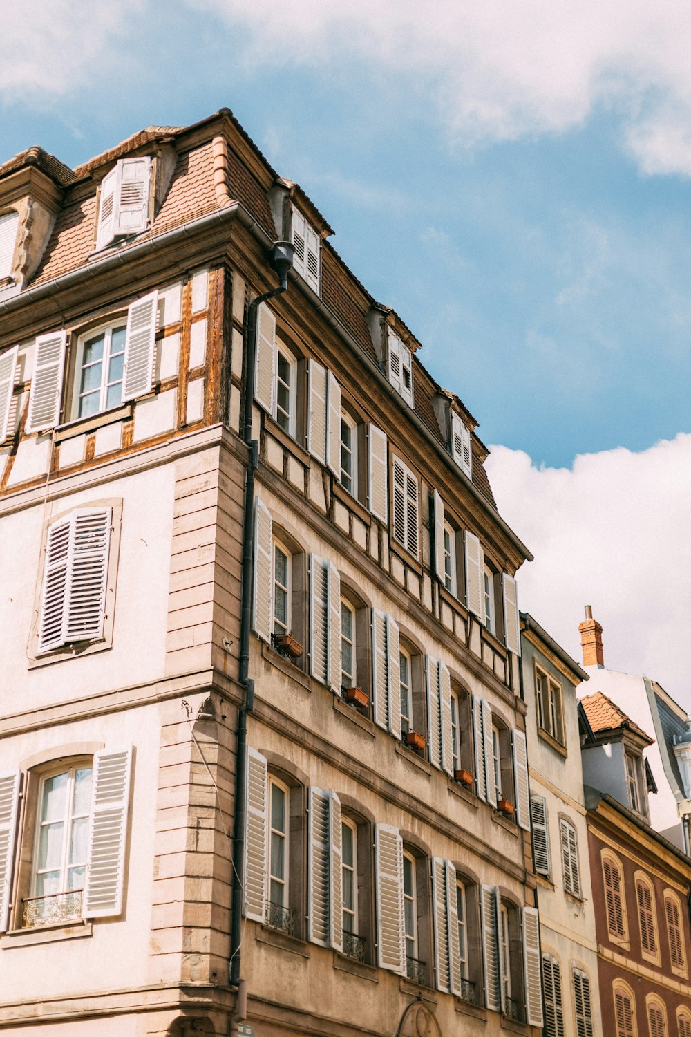 a tall building with lots of windows and shutters