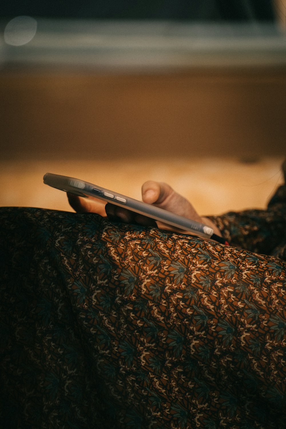 a person holding a cell phone in their hand