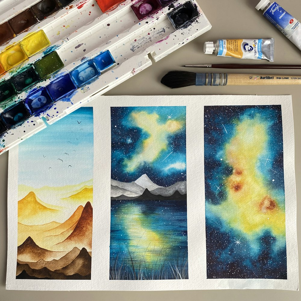 three paintings of mountains and a body of water