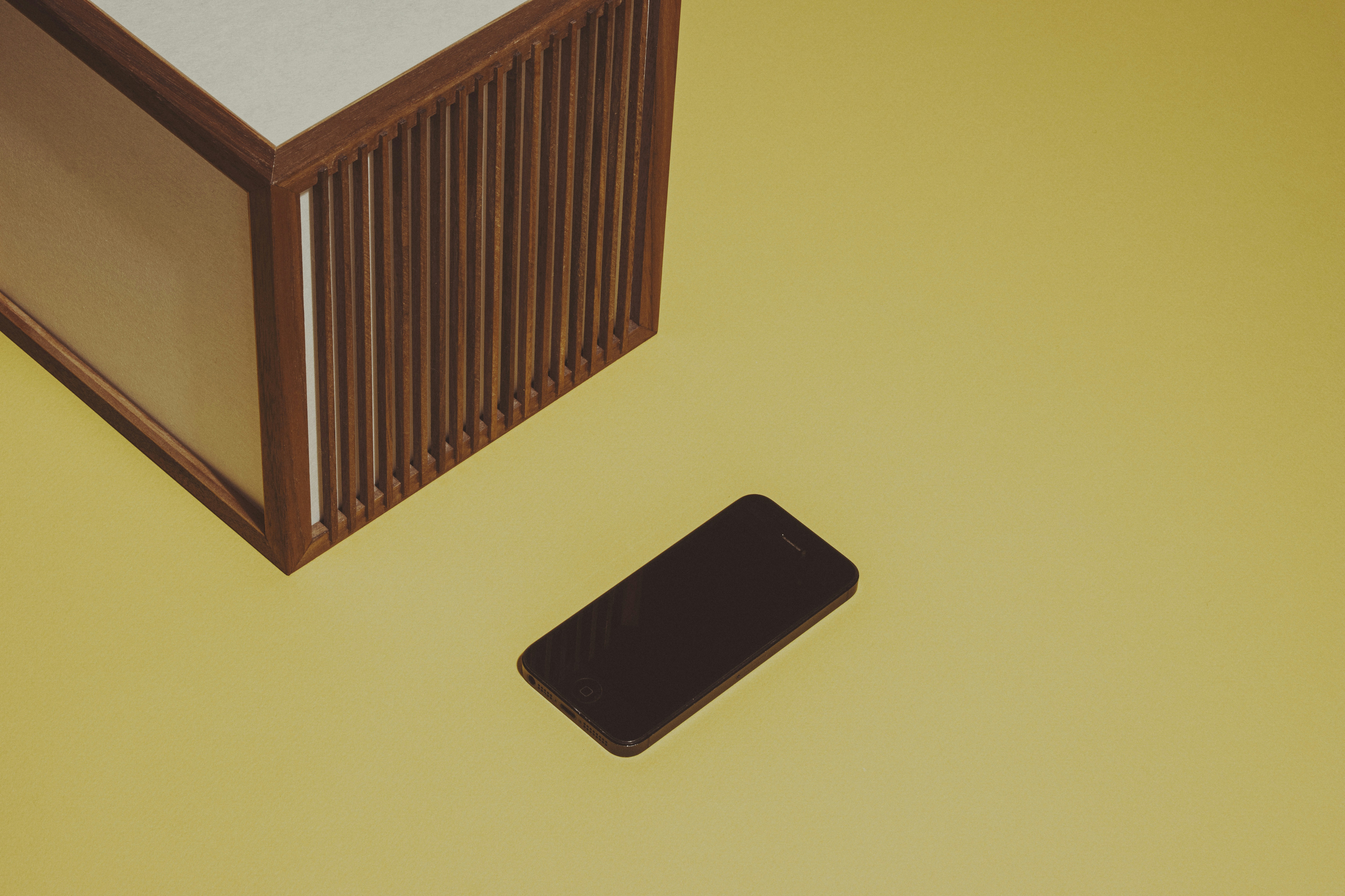 a cell phone sitting on top of a yellow table