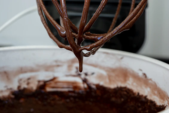 a whisk of chocolate is being stirred by a mixer
