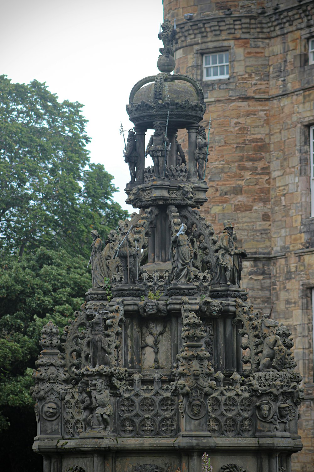 a clock tower with a statue on top of it