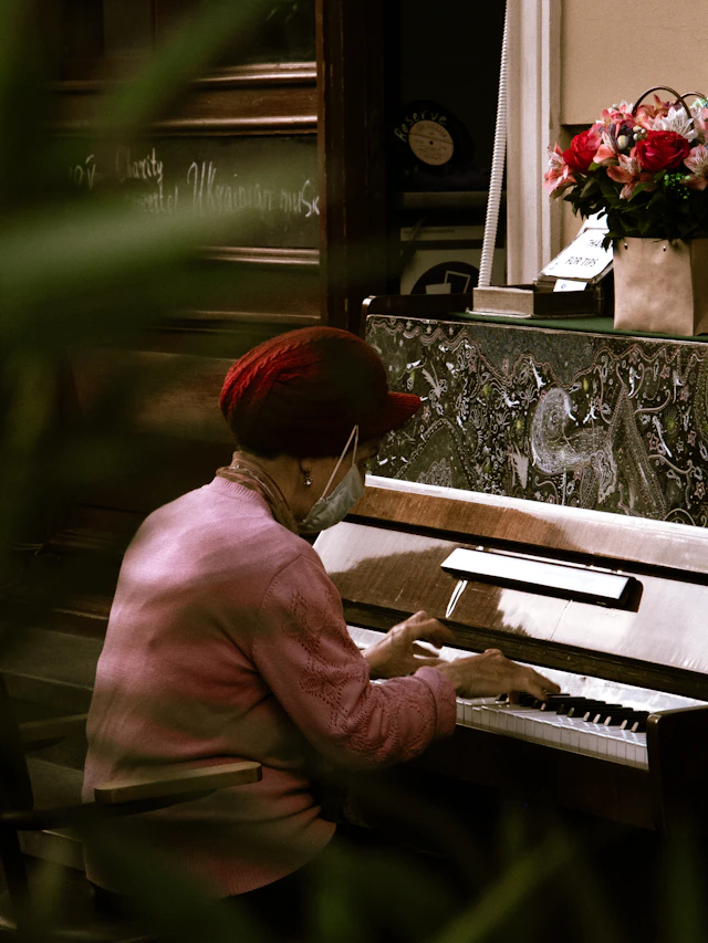 A woman sitting at a piano playing music