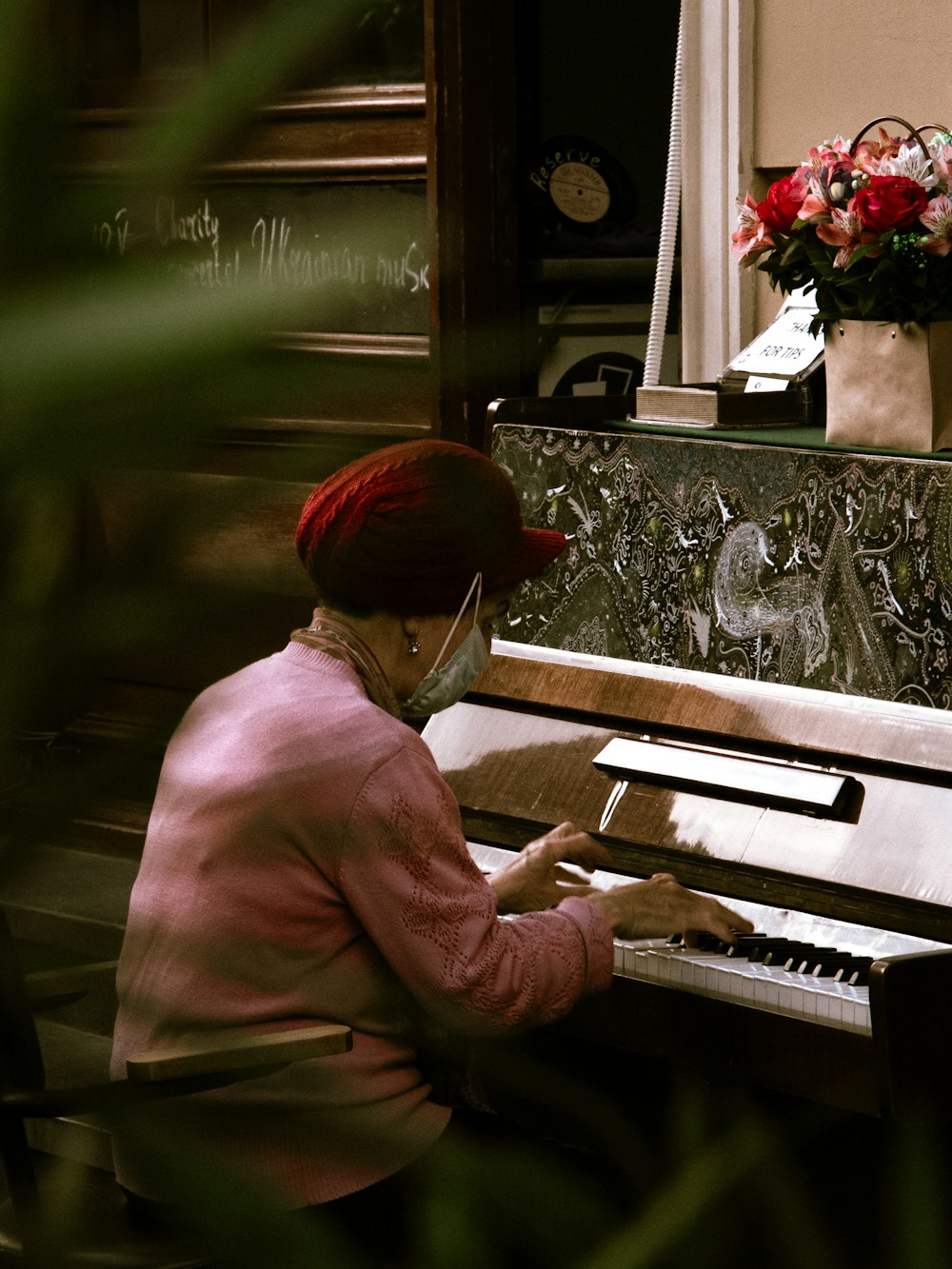 a woman sitting at a piano playing a musical instrument