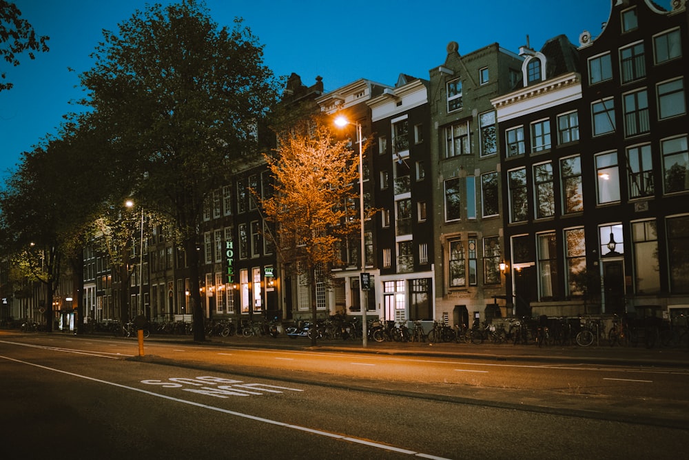 a row of buildings along a street at night