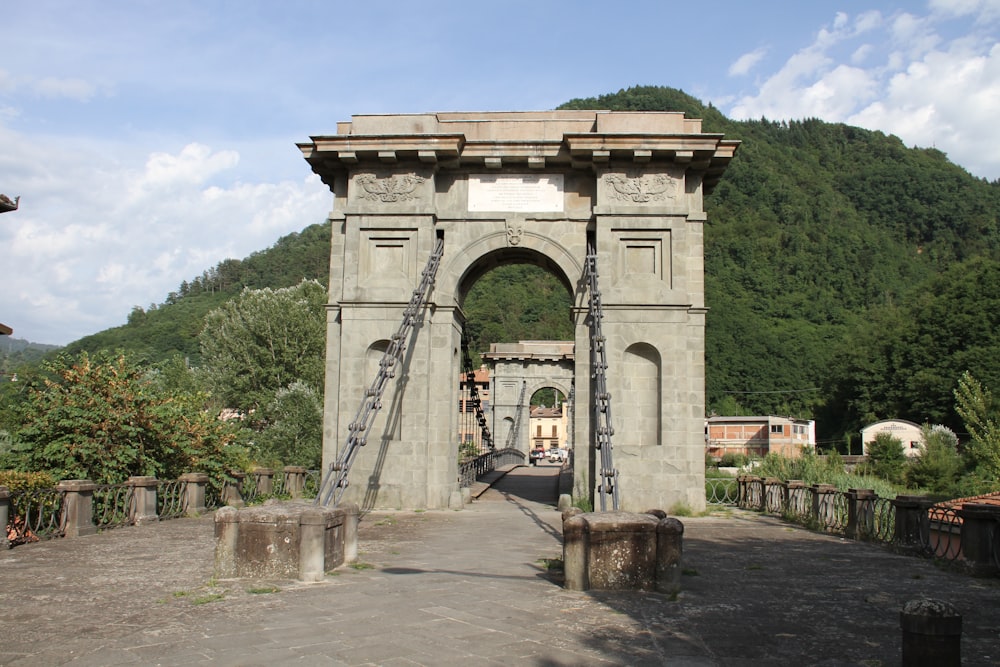 a stone arch with a ladder going through it