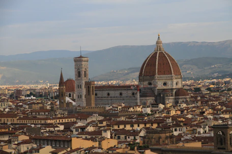 Visitors walking on the rooftop terraces of the Duomo, with panoramic views of Milan’s skyline.