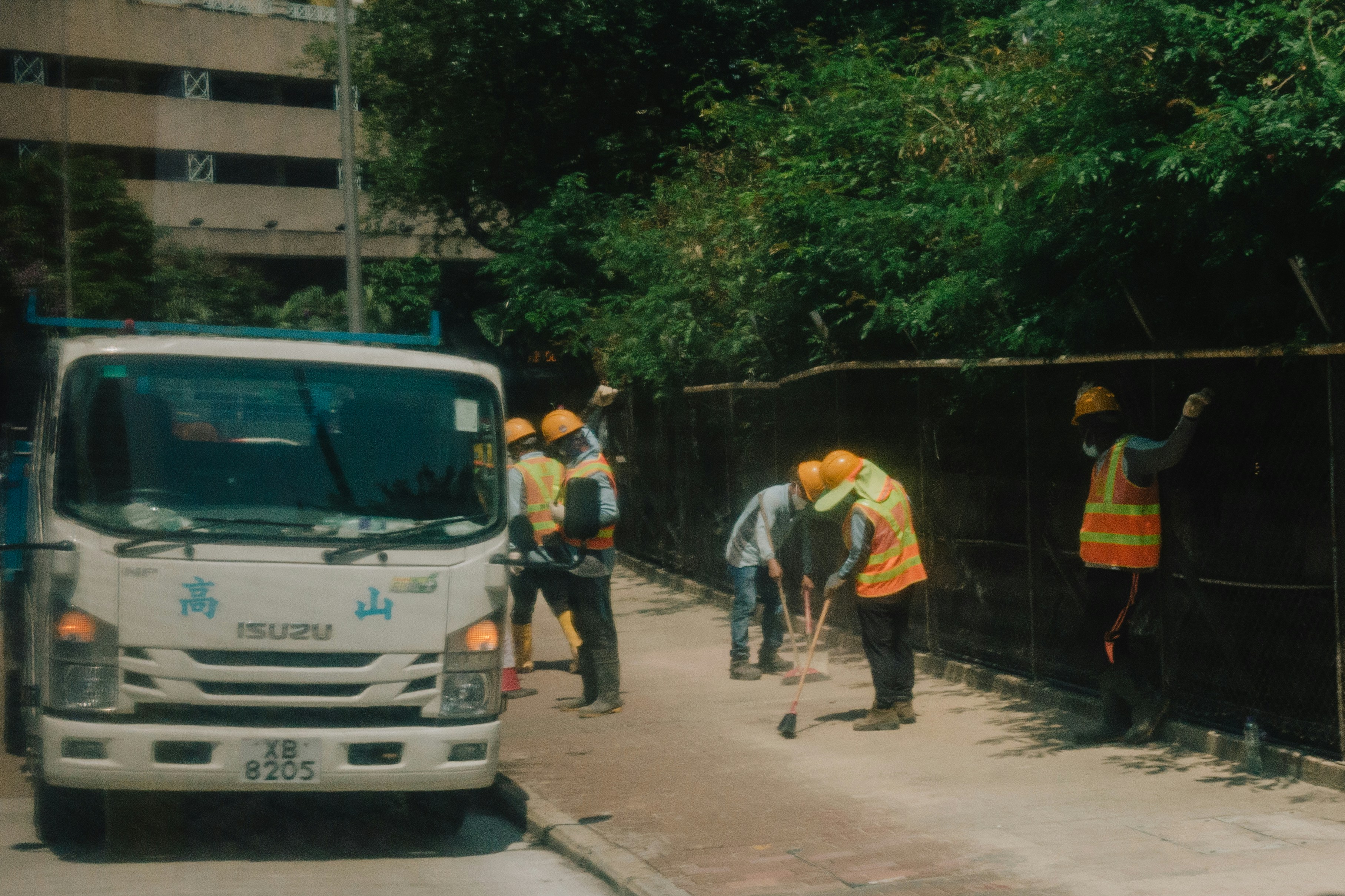 a group of men standing next to a white truck