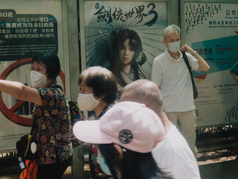 a group of people standing in front of a bus