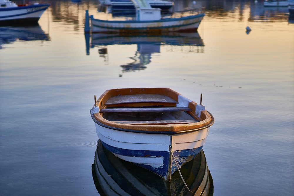 a small boat floating on top of a body of water