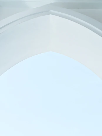 A serene, minimalist interior featuring soft mauve accents and clean architectural lines.