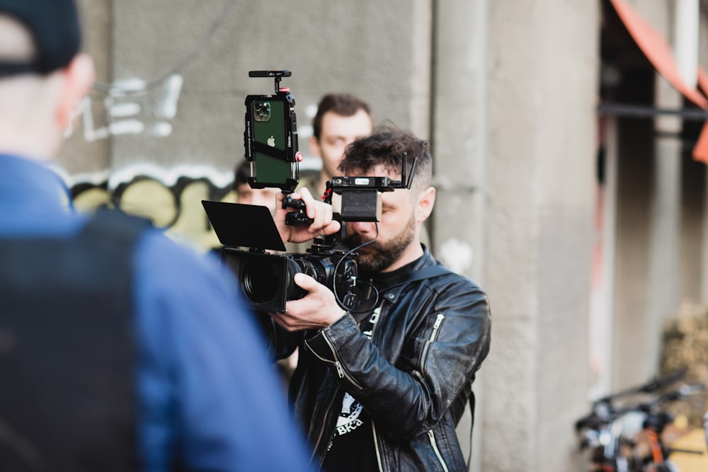 a man taking a picture of another man with a camera