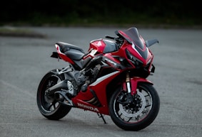 a red motorcycle is parked on the street