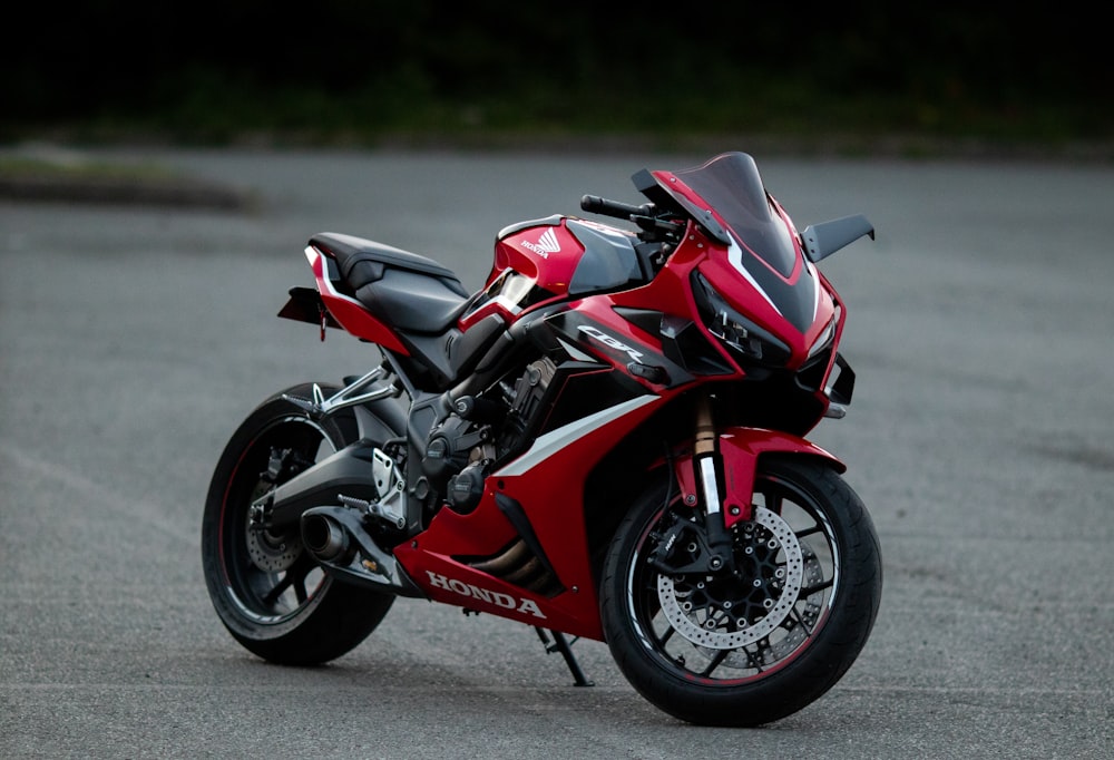 a red motorcycle is parked on the street