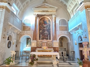 Interior view of the church altar with ancient icons and lit candles