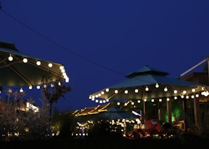 Outdoor patio with a dining table and string lights for evening meals.