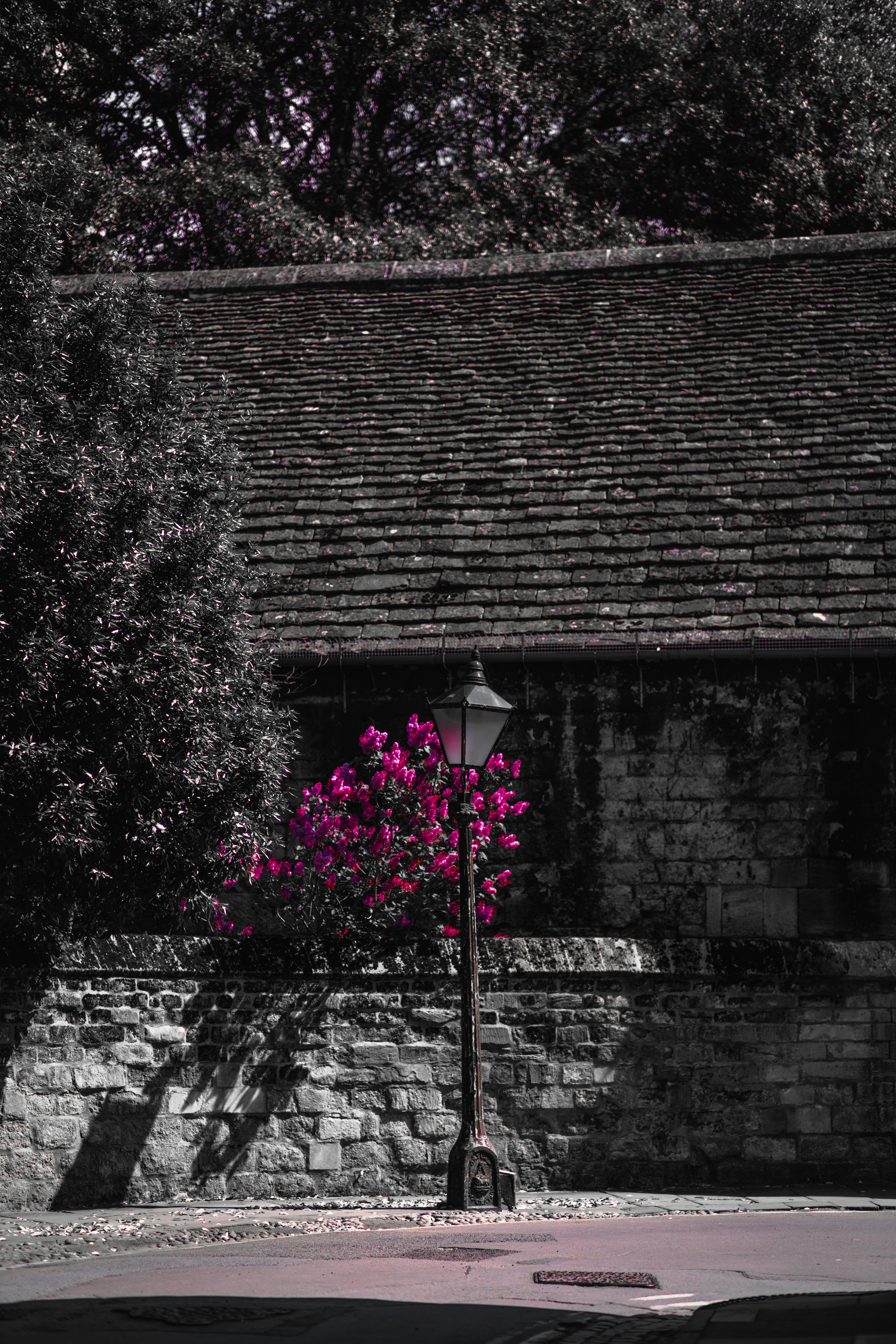 a street light sitting next to a brick building
