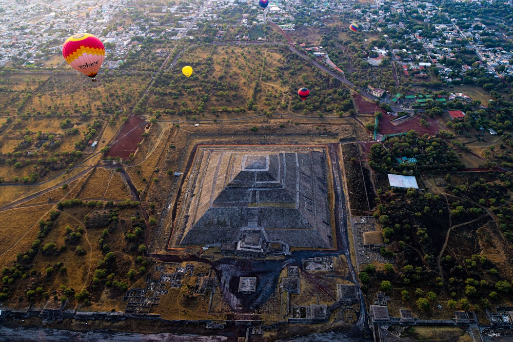 a hot air balloon flying over a city