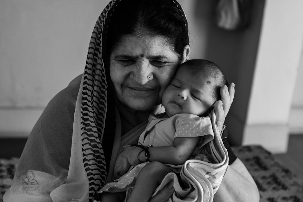 a woman holding a baby in her arms