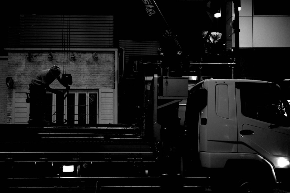 a black and white photo of a man standing on a set of stairs