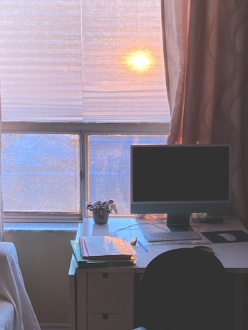 A sparkling clean office desk with sunlight streaming through a freshly washed window.