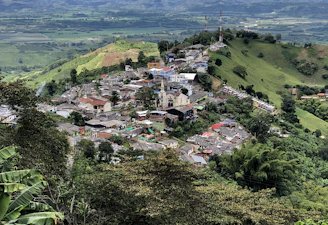a small village nestled on top of a lush green hillside