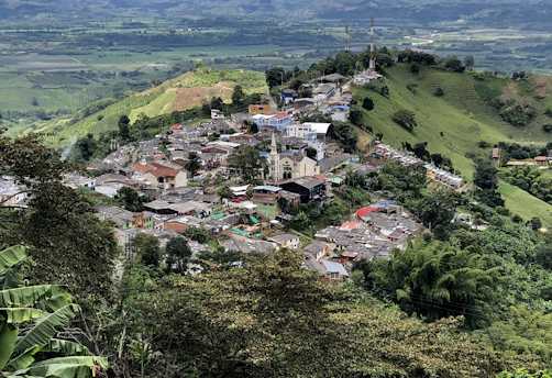 a small village nestled on top of a lush green hillside