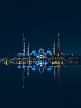 a large body of water with a building in the background
