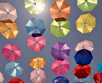 a bunch of colorful umbrellas hanging in the air