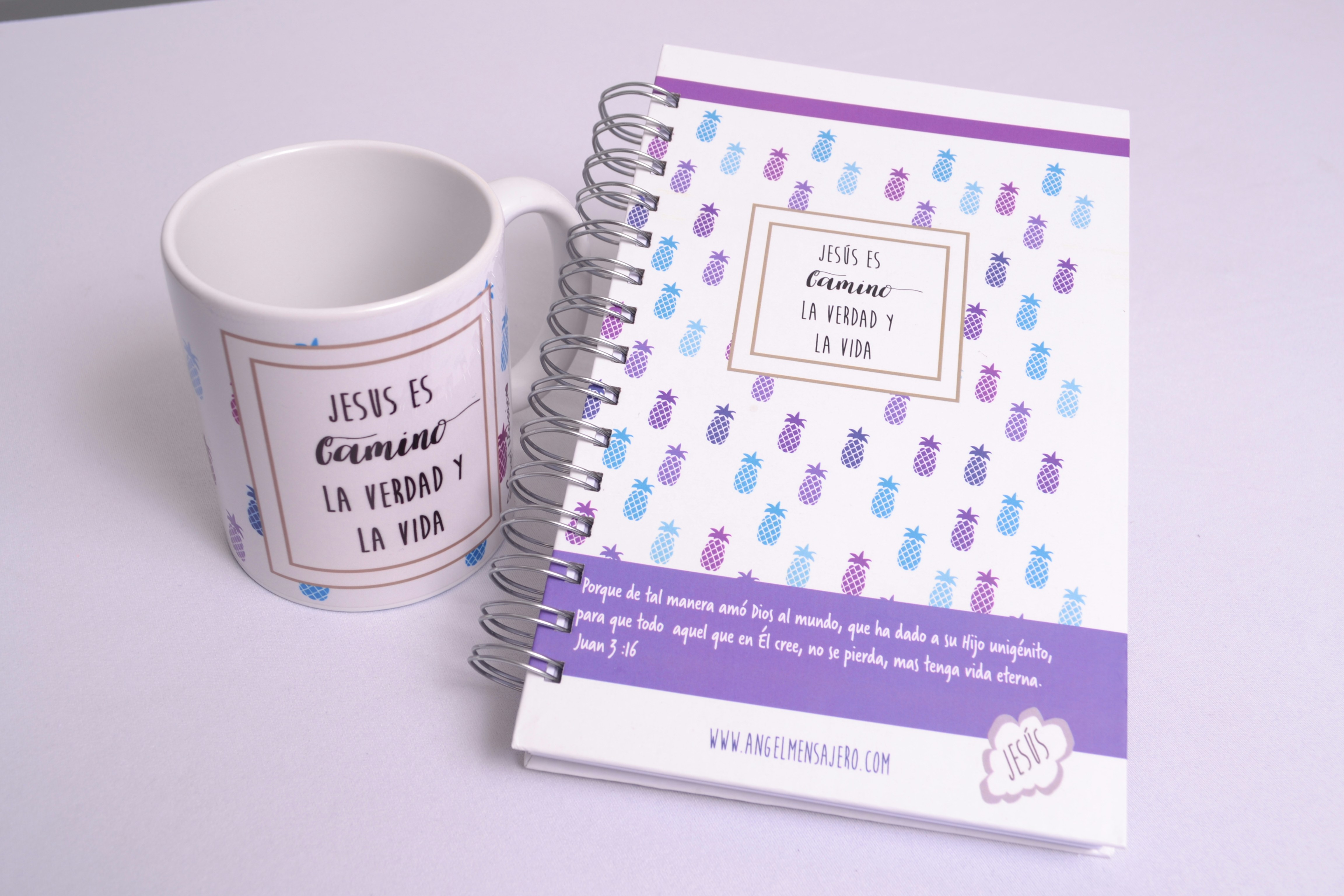 a cup of coffee next to a notebook