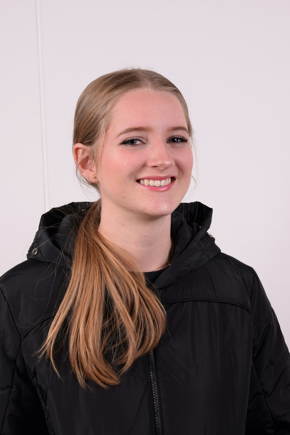 a woman with long hair wearing a black jacket