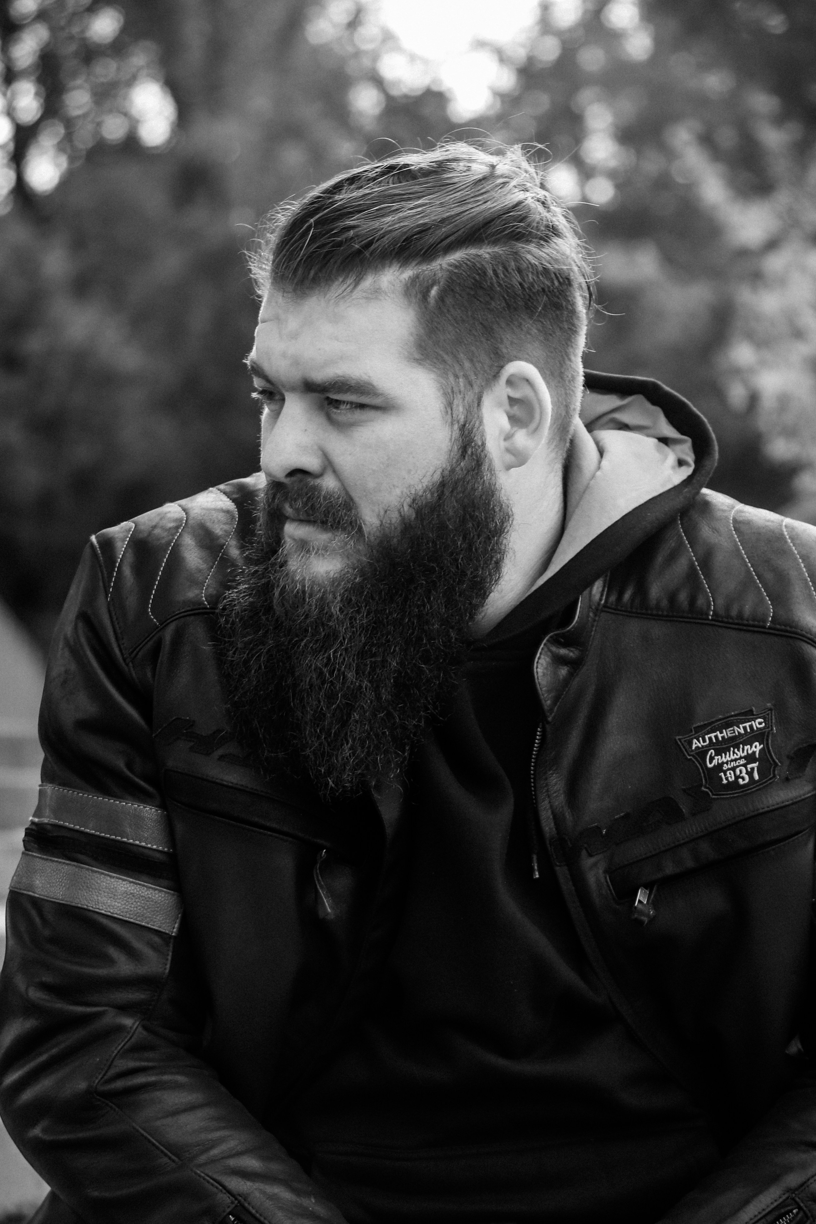 a man with a beard and a leather jacket