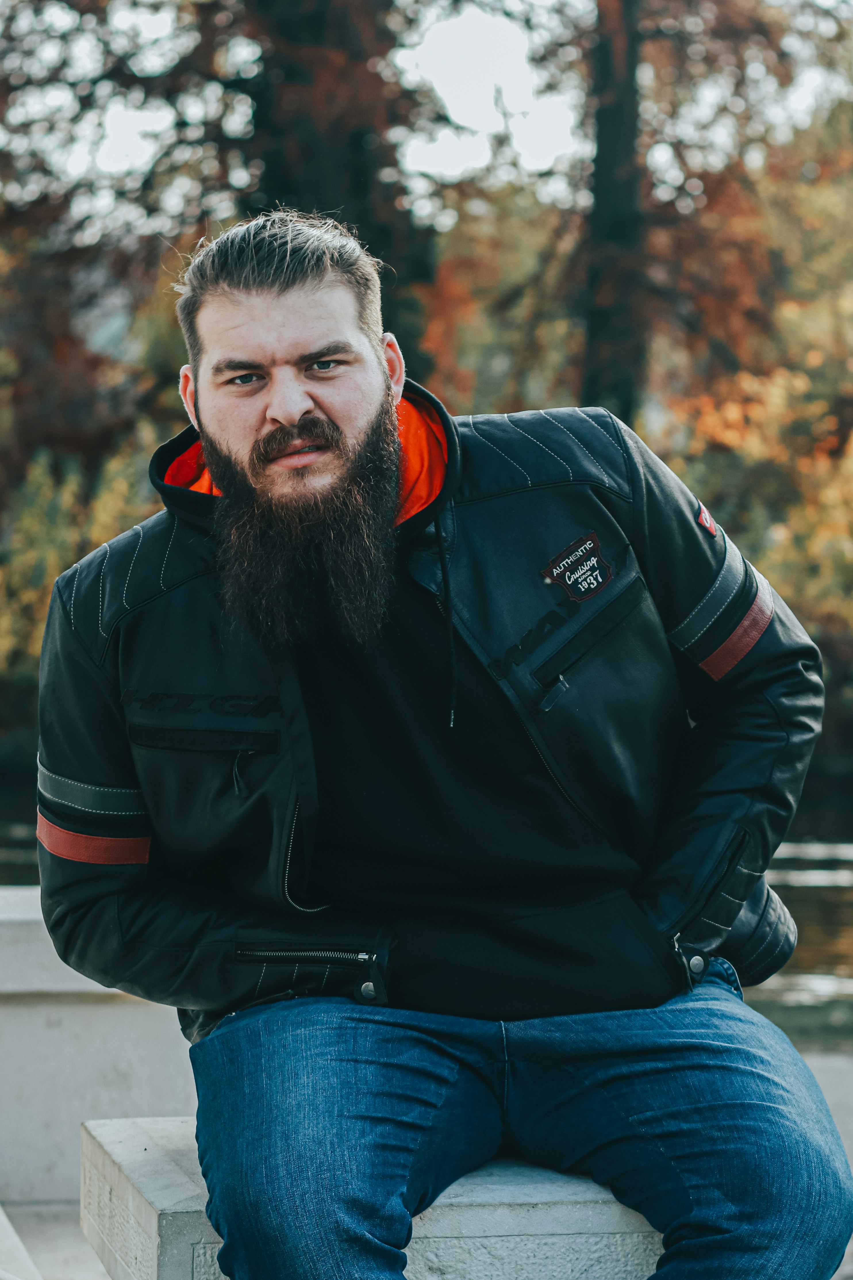 a man with a beard sitting on a bench