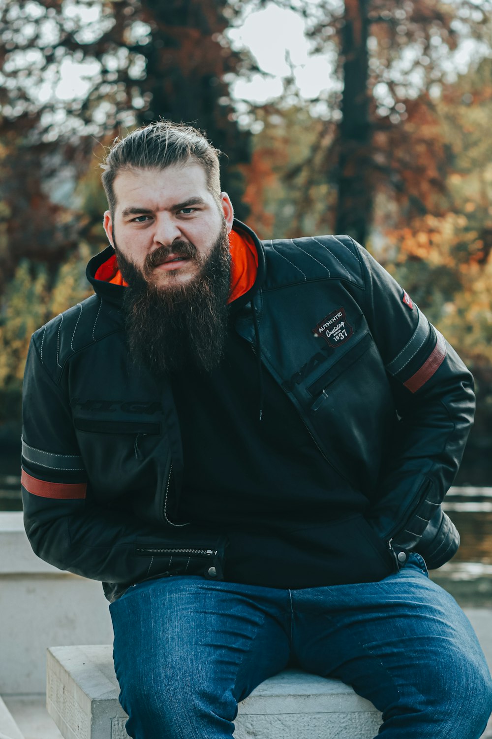 a man with a beard sitting on a bench