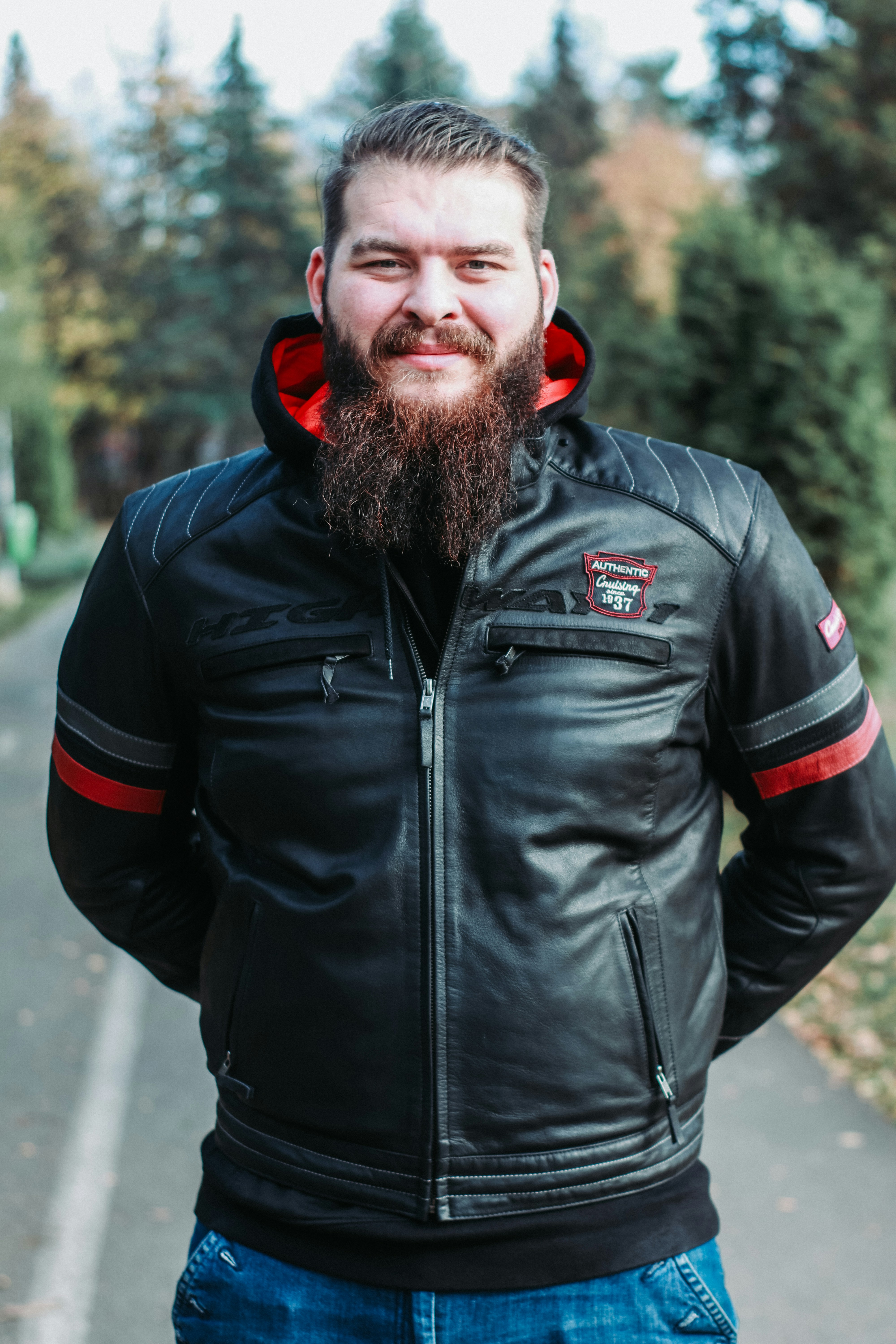a man with a beard wearing a leather jacket