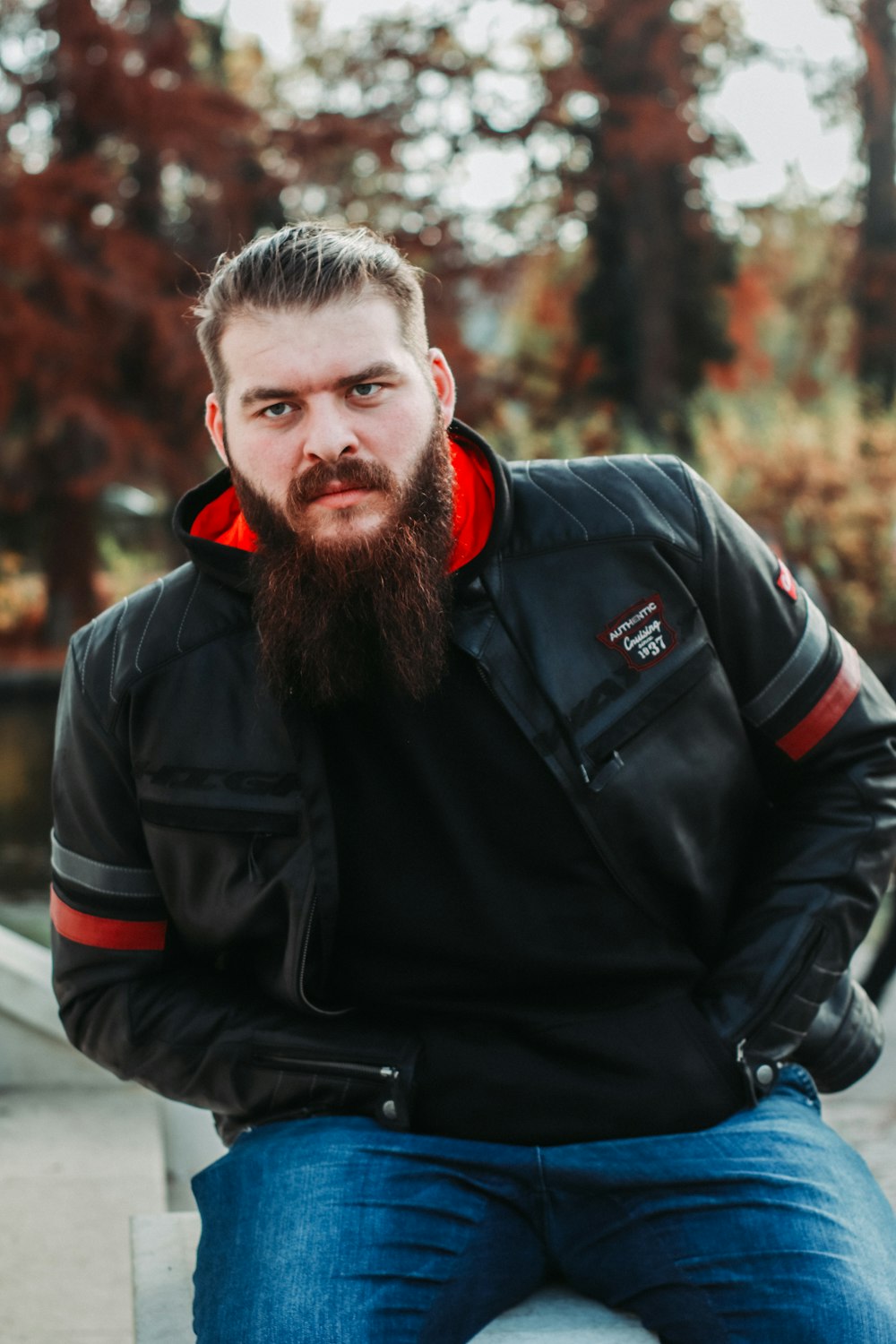 a man with a beard sitting on a bench