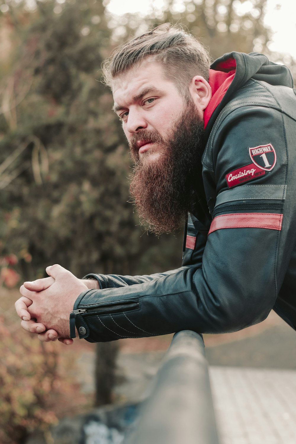 a man with a beard wearing a leather jacket