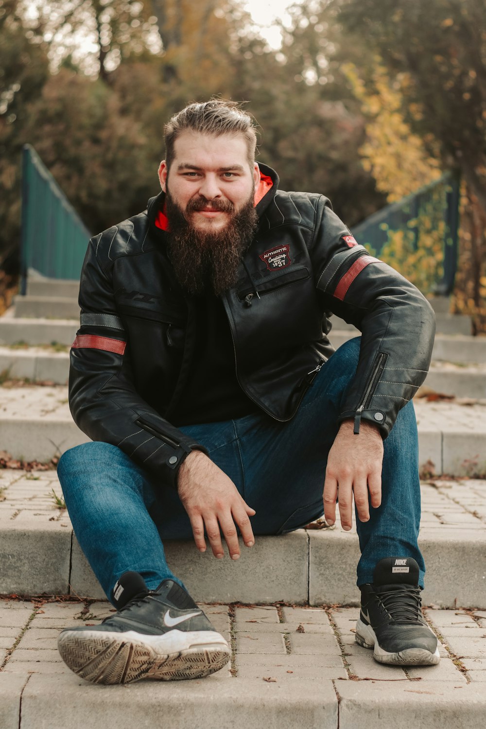 a man with a beard sitting on steps